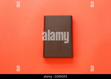 External hard disk isolated on red background. Stock Photo