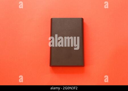 External hard disk isolated on red background. Stock Photo
