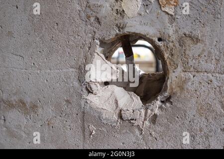 Repairing the wall - Man putting spackle on a hole in the wall Stock Photo