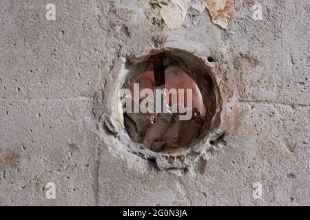 Repairing the wall - Man putting spackle on a hole in the wall Stock Photo