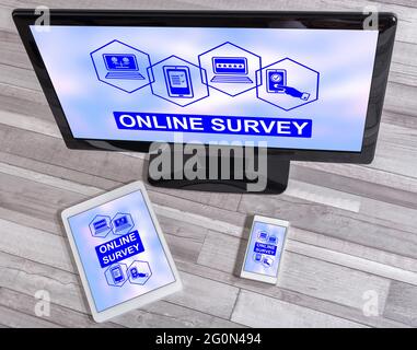 Online survey concept shown on different information technology devices Stock Photo