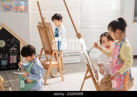 Young women to teach the children in art class Stock Photo