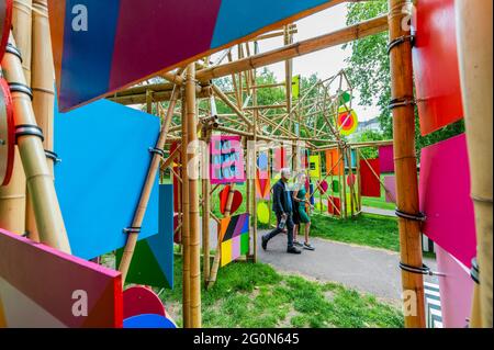 London, UK. 2nd June, 2021. People enjoy the sun and the art - See through by Morag Myerscough as part of wander art supported by Grosvenor Britain and ireland - Public art sculptures by contemporary artists as part of the Mayfair Art Weekend this June. Credit: Guy Bell/Alamy Live News Stock Photo