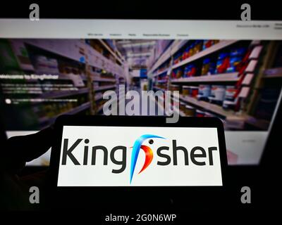 Person holding mobile phone with logo of British investor Bluebell Capital  Partners Limited on screen in front of web page. Focus on phone display  Stock Photo - Alamy