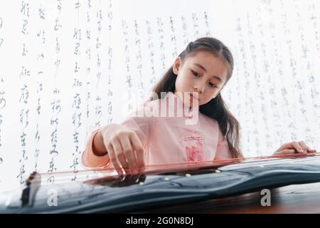 Playing the Chinese zither girl Stock Photo