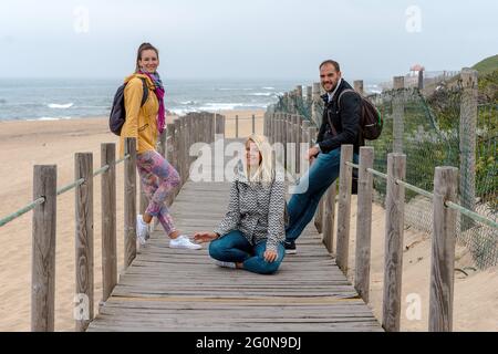 Three friends posing for a photo on the beach Stock Photo
