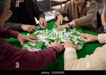 Happy old people playing mahjong Stock Photo