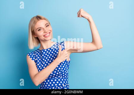 Photo of young cheerful girl happy smile point finger arms muscle biceps sportive isolated over blue color background Stock Photo