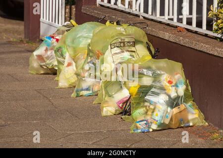 Yellow bags full of plastic waste Stock Photo - Alamy