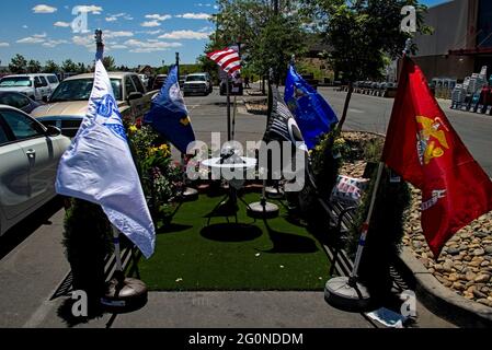 Farmington, New Mexico USA - May 30 2021:Memorial day tribute of flags set up in Lowes hardware store parking lot space reserved for veterans. Stock Photo