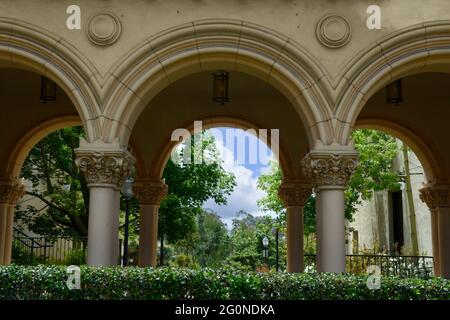Looking through the spanish style architectural archways that span the length of El Prado in Balboa Park, San Diego, CA Stock Photo