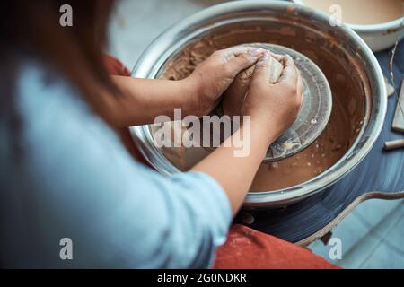 Young woman hands making pottery in workshop Stock Photo