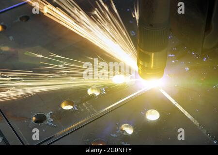 Technological process of cutting sheet metal with a plasma cutting machine with numerical control. Stock Photo