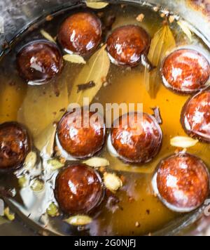 indian sweet Gulab jamun in sweet sugar syrup for the celebration of the festival. Stock Photo