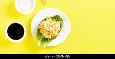 Deep fried vegetable in asian style. Japanese kakiage tempura with sauce and salt. Yellow background with free text space, top view, flat lay Stock Photo