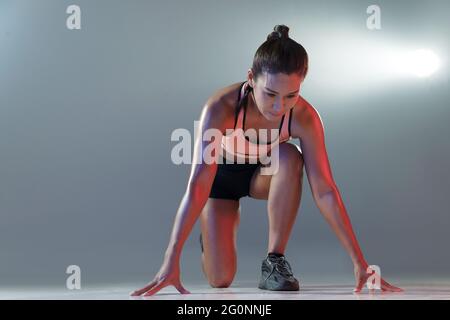 Female athletes ready to start Stock Photo