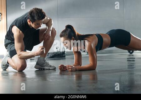 Young woman do tablet support under the guidance of the coach Stock Photo