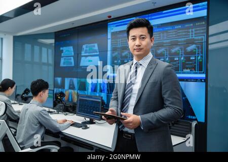 Leadership and technical personnel in the control room Stock Photo