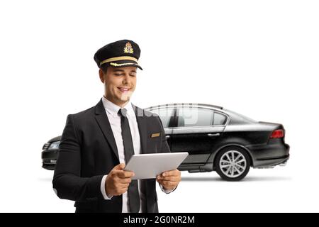 Chauffeur with a black car using a digital tablet isolated on white background Stock Photo