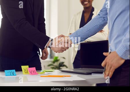 Business people handshake to end successful agreement in office midsection shot Stock Photo