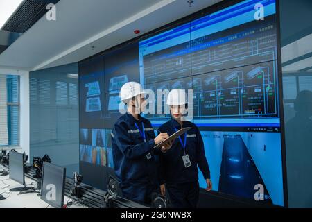 Technical personnel in the control room Stock Photo