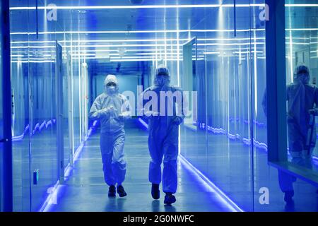 Wearing dusters of technical personnel in the hallway Stock Photo