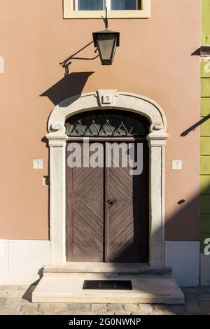 Front door of medieval house with stone frame and street light, Elokapu, Sopron, Hungary Stock Photo