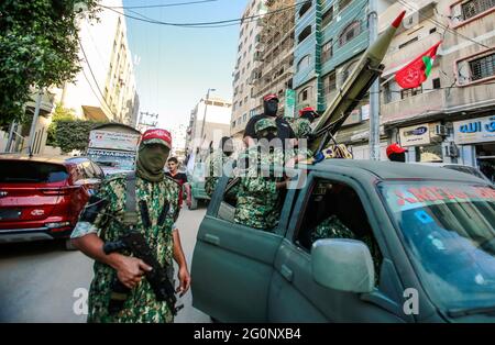 Gaza, Palestine. 02nd June, 2021. Masked armed militants seen during the parade. Palestinian militants from the Popular Front for the Liberation of Palestine (PFLP) parade at a rally just over a week after a cease-fire was reached after an 11-day war between Hamas and Israel in Gaza city. (Photo by Ahmed Zakot/SOPA Images/Sipa USA) Credit: Sipa USA/Alamy Live News Stock Photo