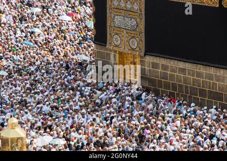 Holy Kaaba in Mecca city. Door of Kaaba - Multazam. Crowd of muslim pilgrims circumambulate - tawaf. Mecca - Saudi Arabia: August 2021 Stock Photo