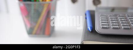 On table are documents diary with a calculator, pencils next to it Stock Photo