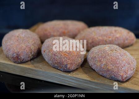 semifinished cutlet on wooden plate ready to cook cutlets Stock Photo