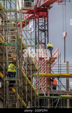 Construction site, large construction site, new construction of a commercial building, workers on scaffolding, shuttering for concrete work, Bochum , Stock Photo