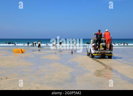 Life guards on safe and sandy Porthmeor beach, popular with surfers and swimmers alike, in St Ives, Cornwall, UK