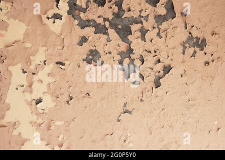Pink orange pastel grunge texture. Peeling cracked paint on old wall.  Stock Photo