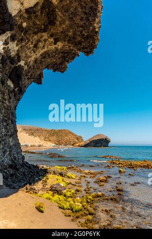 Vertical shot of eroded lava formations in Monsul beach in Almeria, Spain Stock Photo