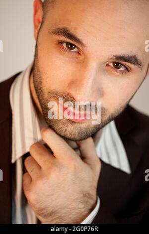 Vertical portrait of a young caucasian male wearing a suit Stock Photo