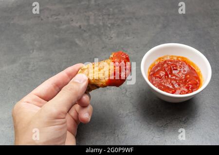 Hot and Spicey Buffalo Chicken Wings. Cooked chicken wings in hand. Deep Fried Chicken Wings Stock Photo
