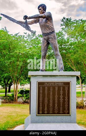 The Golden Fisherman “Casting His Net Into Eternity” statue stands in front of the Maritime and Seafood Industry Museum in Biloxi, Mississippi. Stock Photo