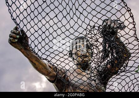 The Golden Fisherman “Casting His Net Into Eternity” statue stands in front of the Maritime and Seafood Industry Museum in Biloxi, Mississippi. Stock Photo