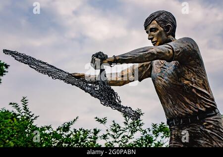 The Golden Fisherman “Casting His Net Into Eternity” statue stands in front of the Maritime and Seafood Industry Museum in Biloxi, Mississippi. Stock Photo