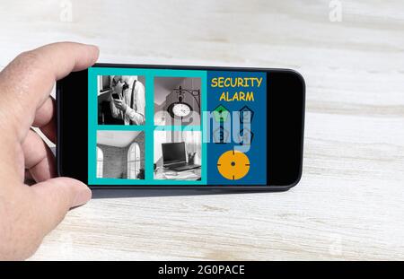 person using the smart phone to observe via wifi the security cameras of the house with several active cameras security concept Stock Photo