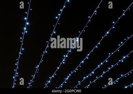 Bright festive lines of cold flickering lights on a black background Stock Photo