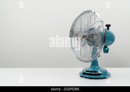 Vintage blue tabletop fan isolated on a white background Stock Photo