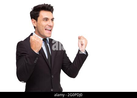 Excited young businessman keeping arms raised and expressing positivity isolated on white background, Celebrating success concept Stock Photo