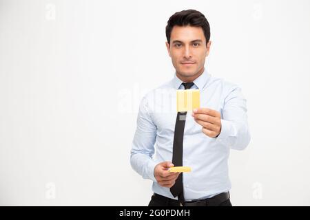Businessman holding orange sticky note isolated over white background Stock Photo