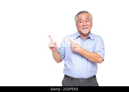Asian senior man smiling and pointing to empty copy space isolated on white background Stock Photo