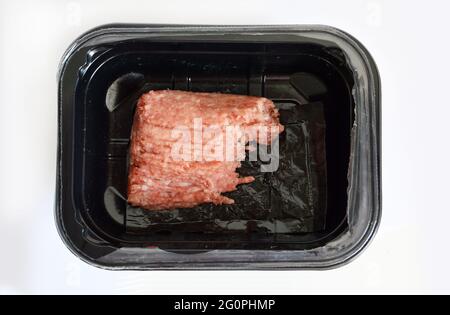 Minced pork in plastic container against white background Stock Photo