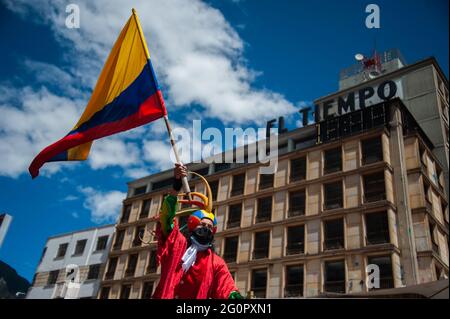 Pasto, Narino on June 2, 2021, A demonstrator waves a Colombian national flag as Colombians demonstrate a t the start of the fifth week of anti-government protests against President Ivan Duque's health and tax reforms and police brutality that leaves at least 70 dead in the past month of protests, on June 2, 2021 in Bogota, Colombia Stock Photo