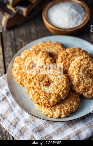 Sweet coconut cookies. Tasty biscuits with coconut flavor on plate. Stock Photo