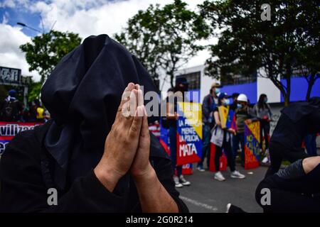 Pasto, Narino, Colombia. 2nd June, 2021. Protester puts his hands in prayer for the violence that has left the national strike in Colombia in Pasto, Narino on June 2, 2021 during an anti-government protest against president Ivan Duque's tax and health reforms and unrest and violance caused in police abuse of power cases that leave at leas 70 dead since the protests errupted back on april 28. Credit: Camilo Erasso/LongVisual/ZUMA Wire/Alamy Live News Stock Photo